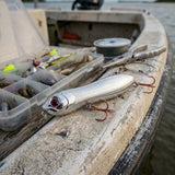 4-inch Silver Bullet Knocker lure on boat gunwale with inshore saltwater tackle