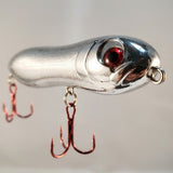 Macro close-up of 4-inch Silver Bullet Knocker lure 3D eye and treble hook